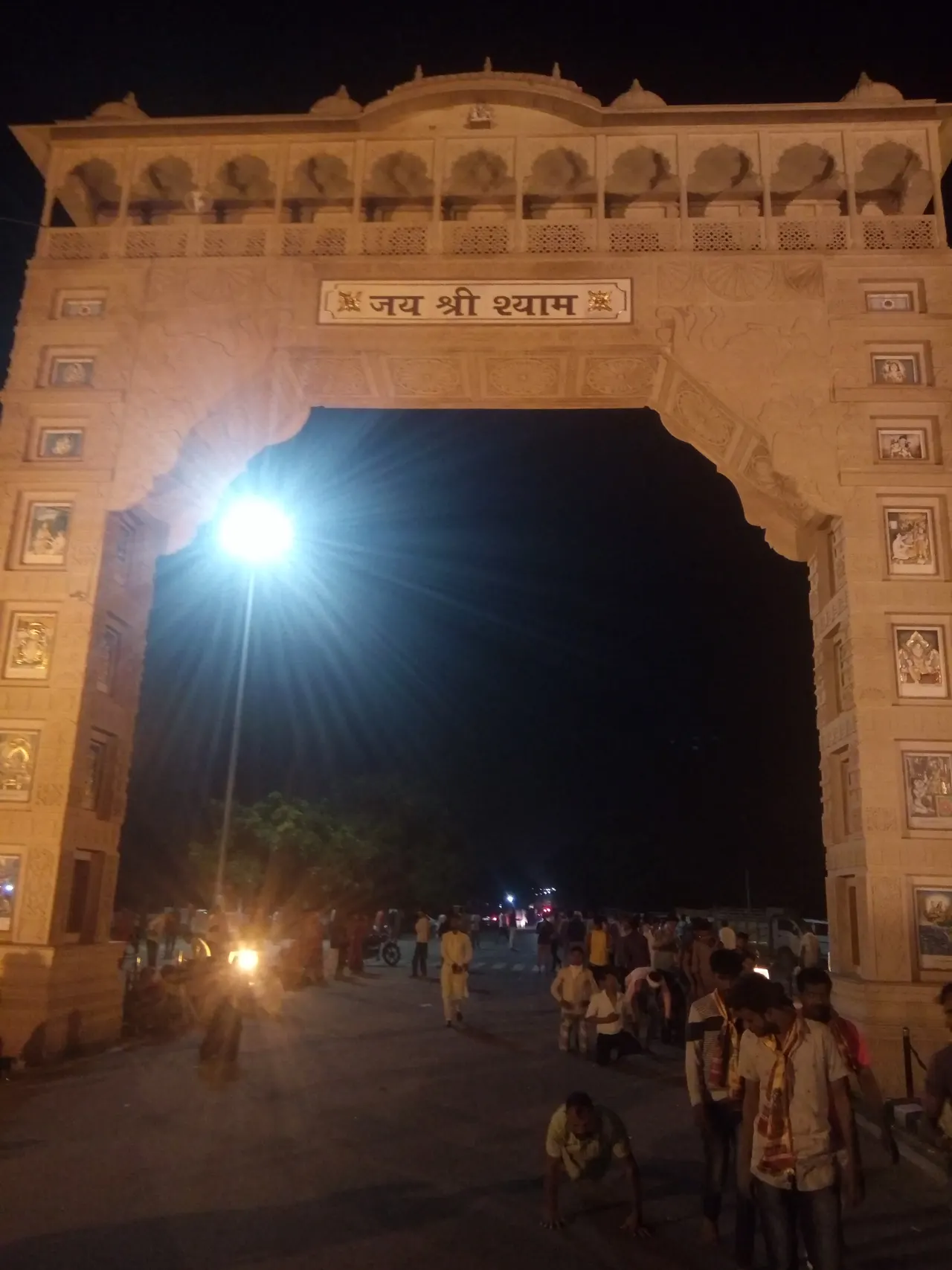 Illuminated gateway at Khatu Shyam at night